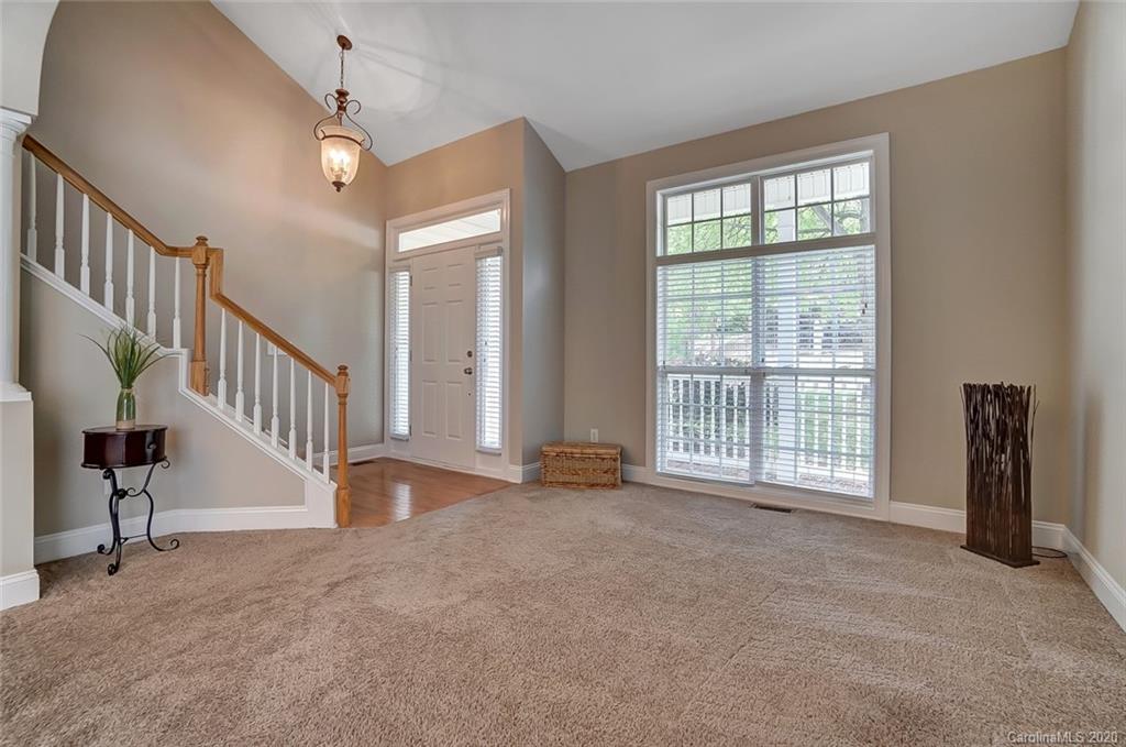 14010 Wild Elm Road Charlotte, NC 28277 - Photo 3 of 36 a view of an empty room with stairs and a window