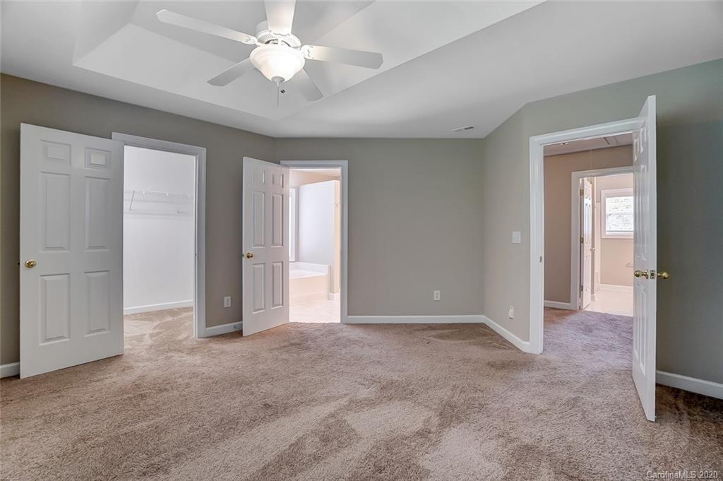14010 Wild Elm Road Charlotte, NC 28277 - Photo 22 of 36 an empty room with closet and a ceiling fan