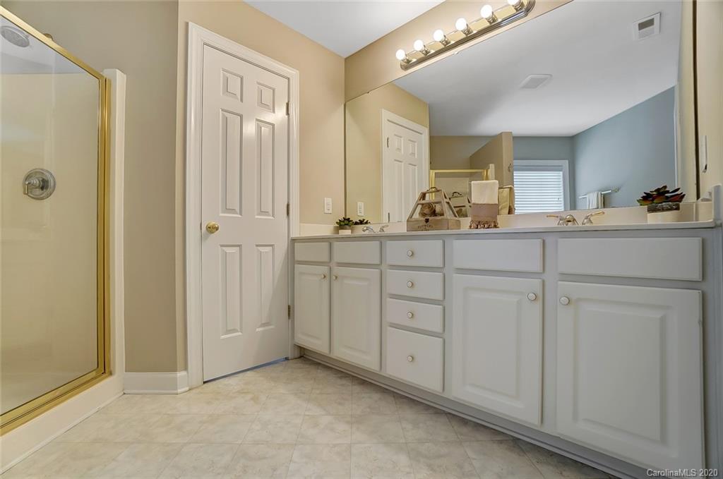 14010 Wild Elm Road Charlotte, NC 28277 - Photo 23 of 36 a bathroom with a sink and a mirror