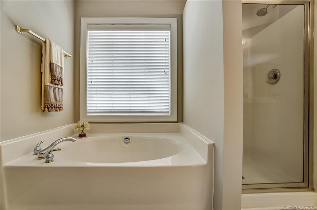 14010 Wild Elm Road Charlotte, NC 28277 - Photo 24 of 36 a white bath tub sitting next to a window