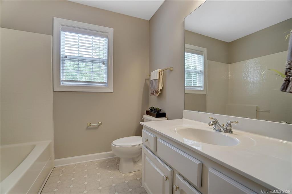 14010 Wild Elm Road Charlotte, NC 28277 - Photo 29 of 36 a bathroom with a sink a toilet and tub