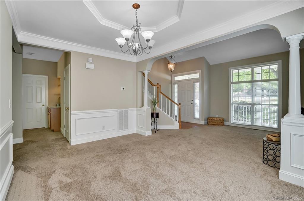 14010 Wild Elm Road Charlotte, NC 28277 - Photo 7 of 36 an empty room with chandelier and windows