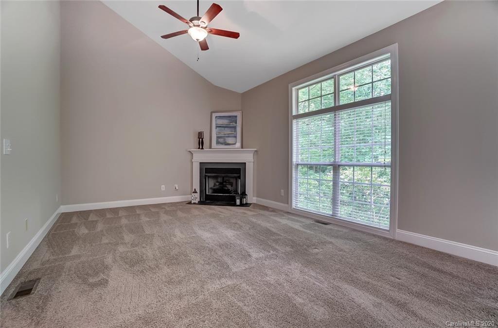 14010 Wild Elm Road Charlotte, NC 28277 - Photo 8 of 36 an empty room with windows and fireplace
