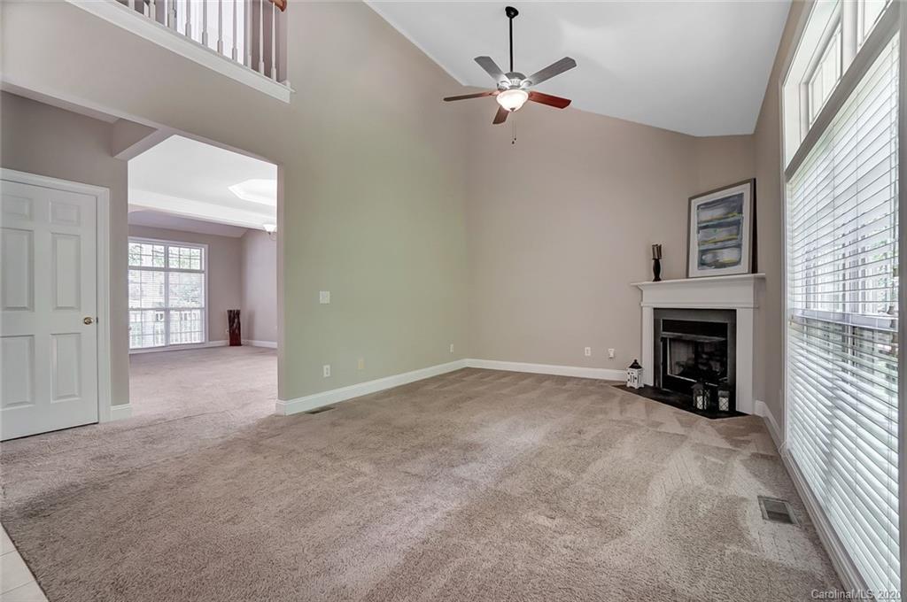 14010 Wild Elm Road Charlotte, NC 28277 - Photo 9 of 36 en empty room with windows and fireplace