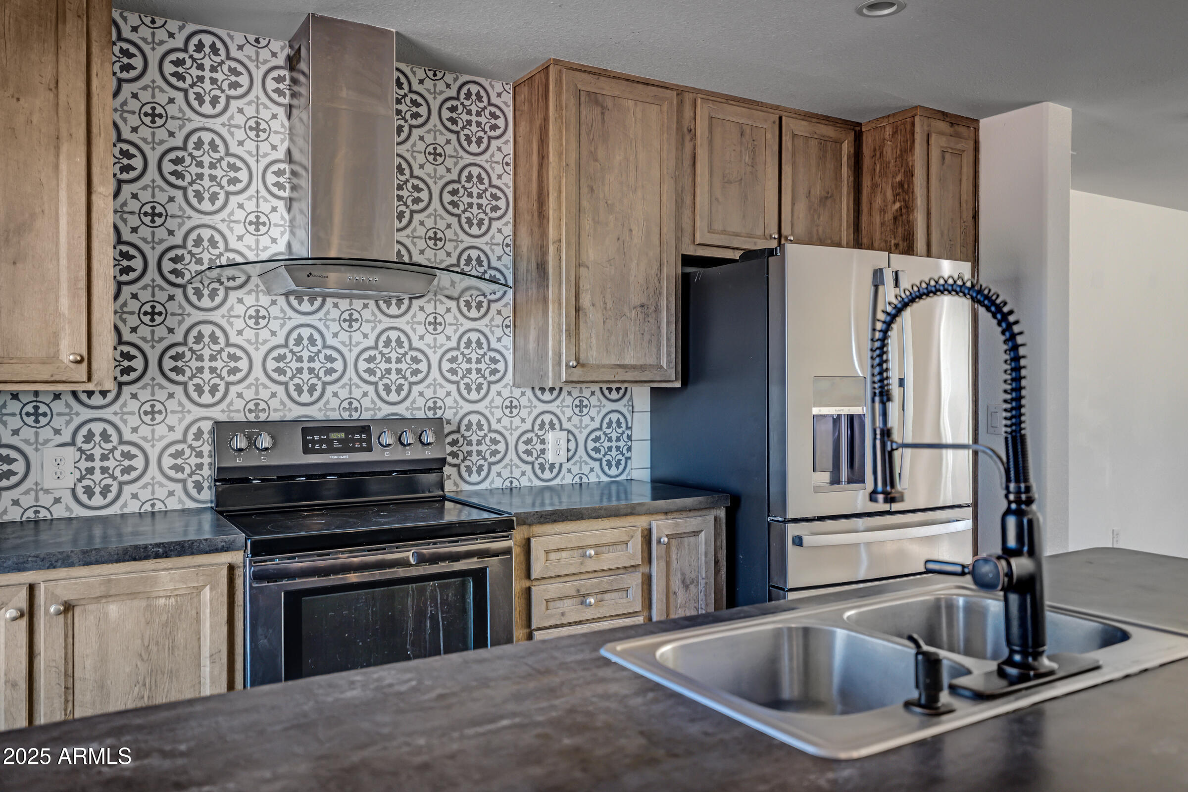 11341 East 6th Avenue Apache Junction, AZ 85120 - Photo 11 of 37 a kitchen with stainless steel appliances granite countertop a sink stove and refrigerator