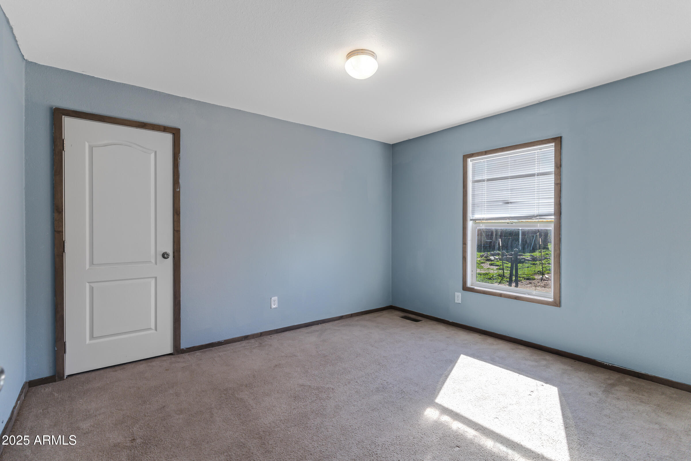 11341 East 6th Avenue Apache Junction, AZ 85120 - Photo 18 of 37 an empty room with a window