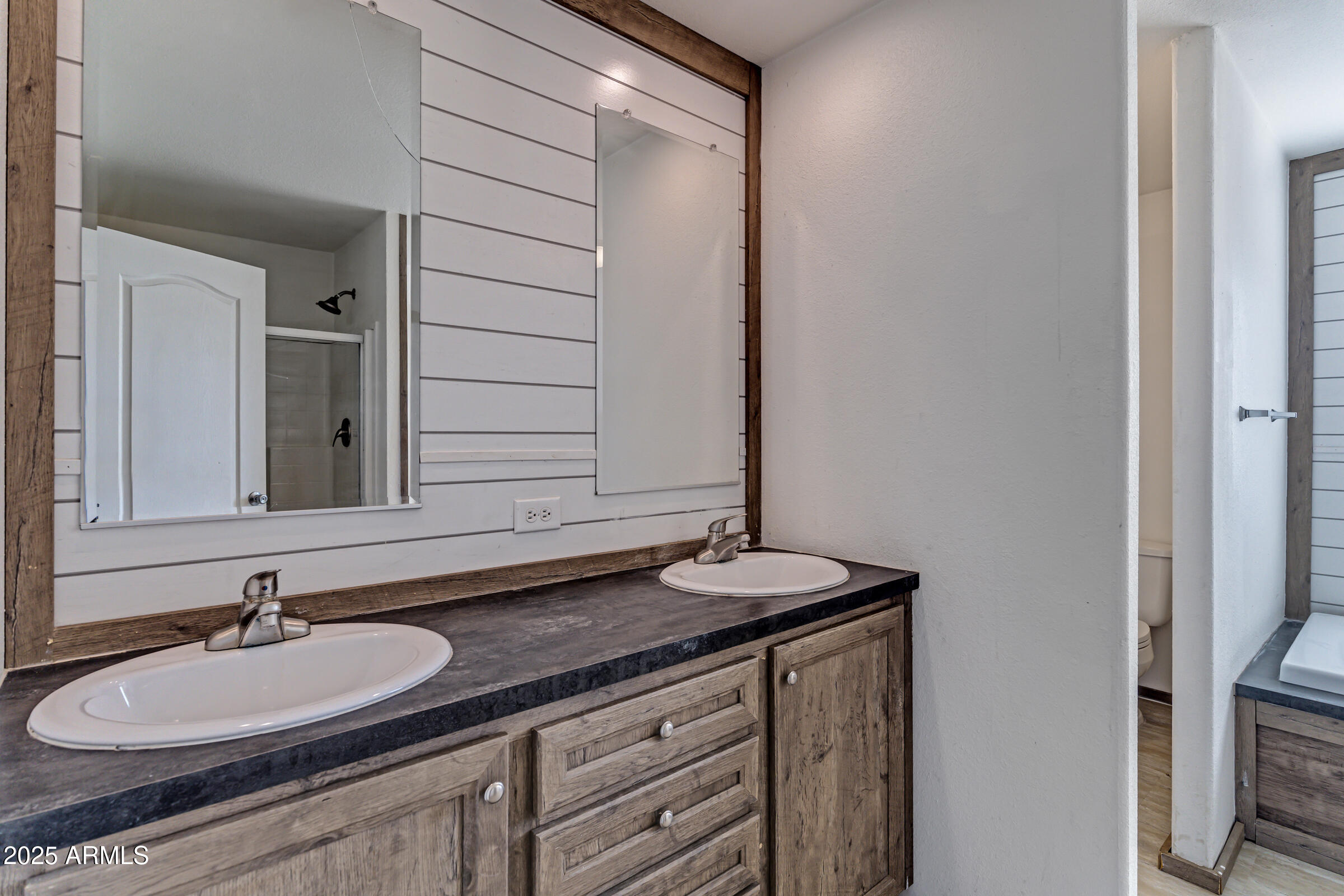 11341 East 6th Avenue Apache Junction, AZ 85120 - Photo 26 of 37 a bathroom with a granite countertop sink and a mirror
