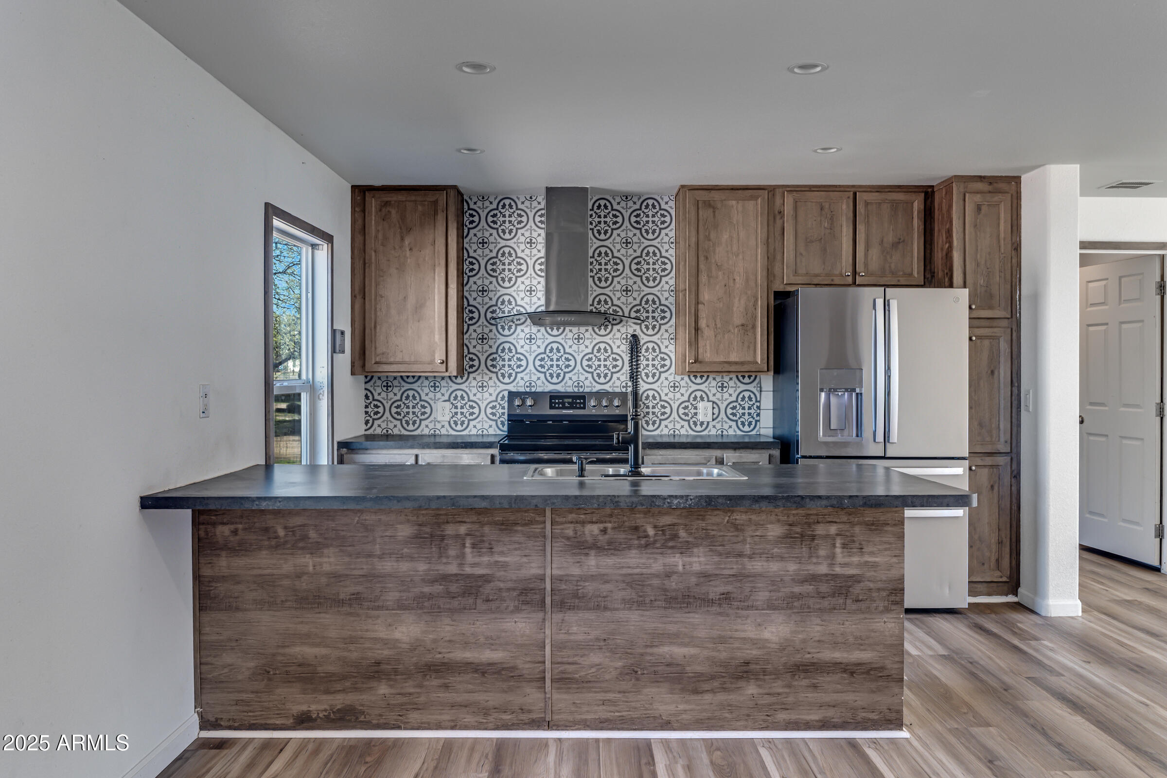 11341 East 6th Avenue Apache Junction, AZ 85120 - Photo 9 of 37 a kitchen with kitchen island a counter top space a sink and refrigerator