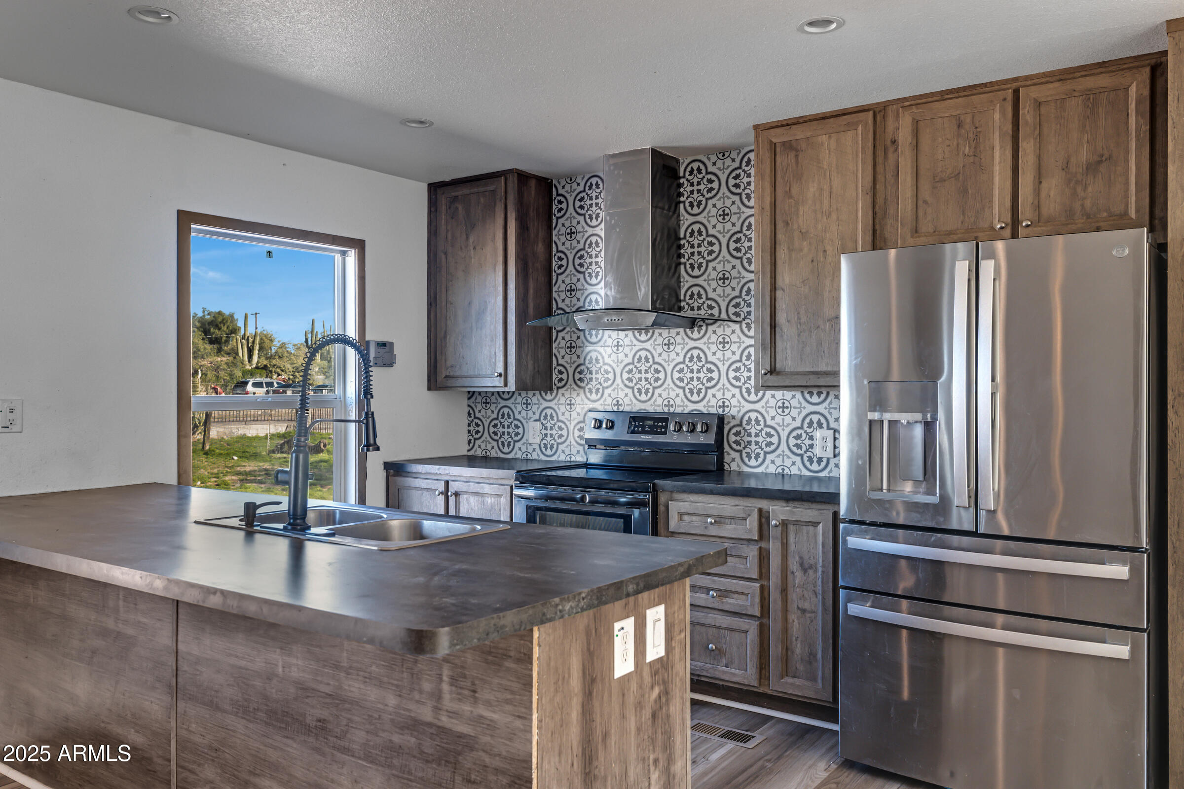11341 East 6th Avenue Apache Junction, AZ 85120 - Photo 10 of 37 a kitchen with stainless steel appliances granite countertop a refrigerator a stove and a sink with wooden floor