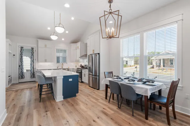 a kitchen with refrigerator cabinets and wooden floor
