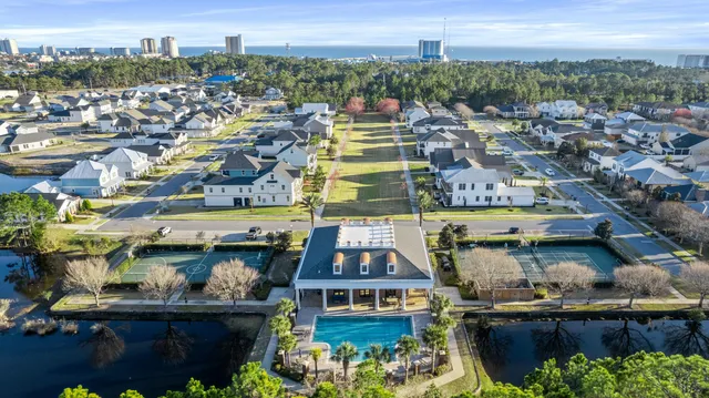 a view of a patio with couches table and chairs and potted plants