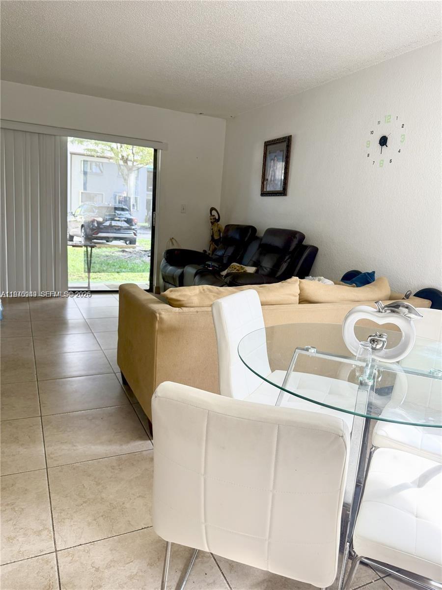 7405 Southwest 152nd Avenue, Unit 105 Miami, FL 33193 - Photo 3 of 9 a living room with furniture