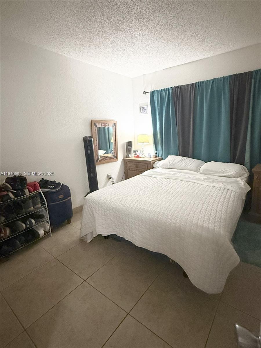 7405 Southwest 152nd Avenue, Unit 105 Miami, FL 33193 - Photo 5 of 9 a bedroom with a bed and a closet
