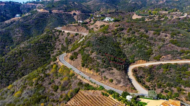 a view of a yard with mountains in the background