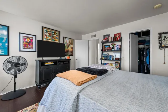 a bedroom with a bed and a bookshelf