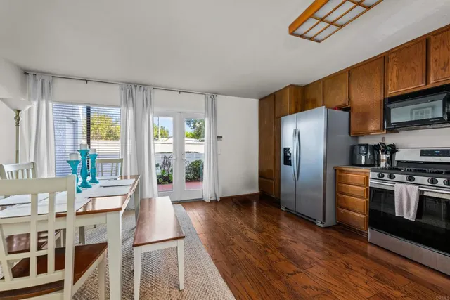 a kitchen with stainless steel appliances a refrigerator and a stove top oven