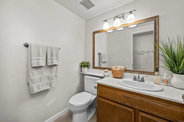 a bathroom with a sink toilet and mirror