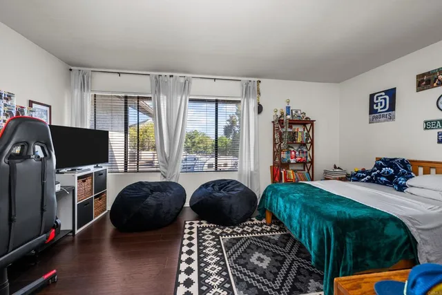 a bedroom with furniture and a flat screen tv