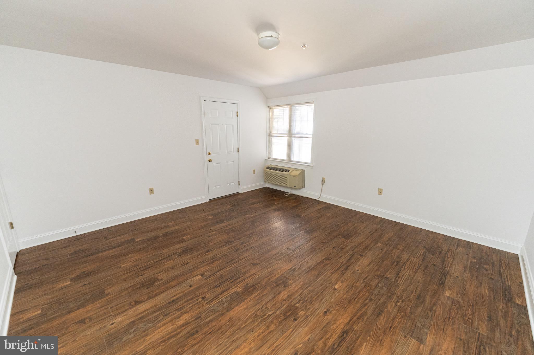 804 Travers Street, Unit 2 Cambridge, MD 21613 - Photo 3 of 26 wooden floor in a room