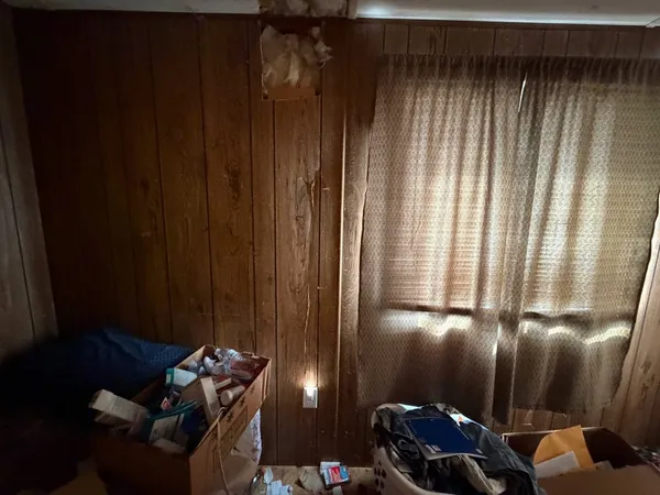 a bed sitting in a bedroom next to a window