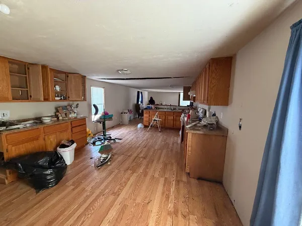 a view of a livingroom with furniture hardwood floor and workspace