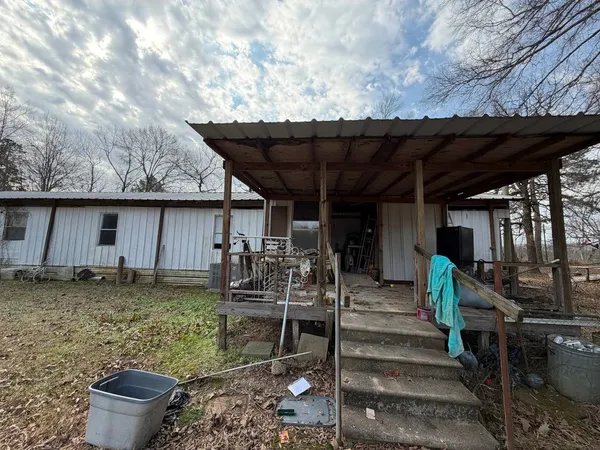 a backyard of a house with barbeque oven table and chairs