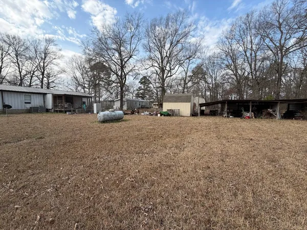 a view of large house with a yard covered in snow
