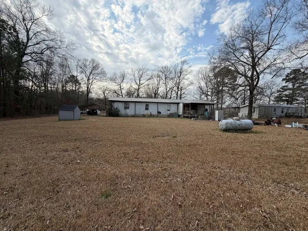 a view of a barn in the middle of a yard