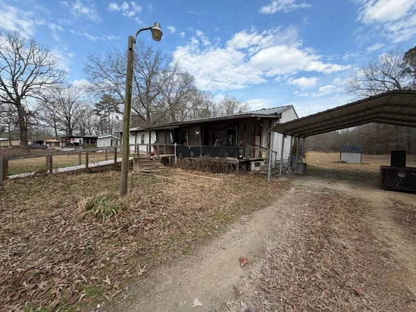 a view of a field with trees in the background