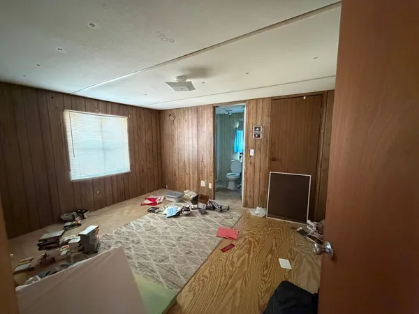 a bedroom with a bed and a desk