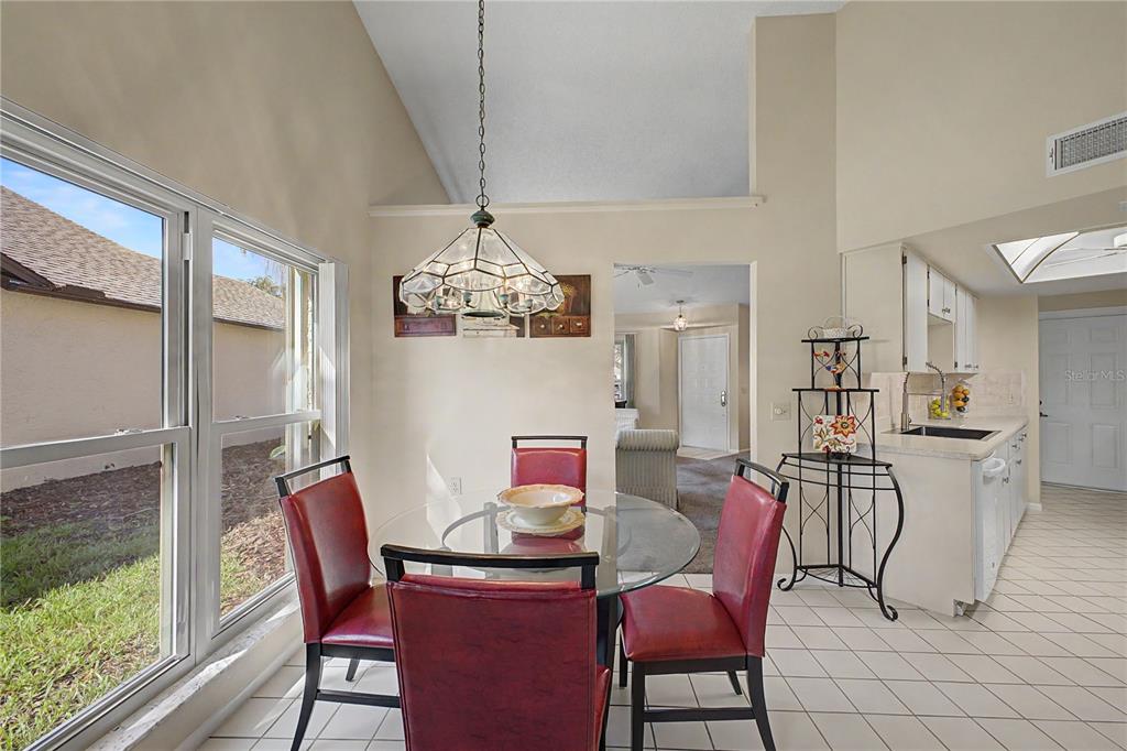 2662 Appleleaf Court Spring Hill, FL 34606 - Photo 10 of 47 a view of a dining room with furniture a chandelier and wooden floor