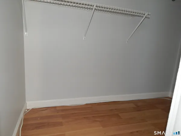 a view of a room with wooden floor and fan