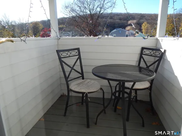 a view of a chairs and table in patio