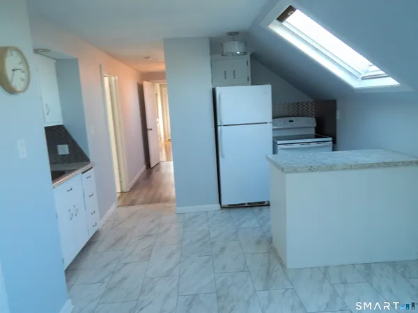 a kitchen with refrigerator and microwave