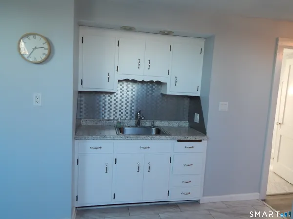 a kitchen with cabinets appliances and a window