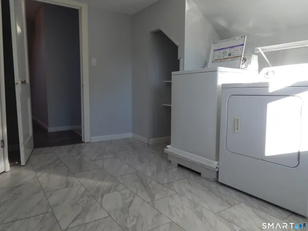 a view of storage and utility room with washer and dryer