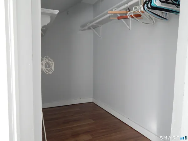 a view of storage and utility room with wooden floor