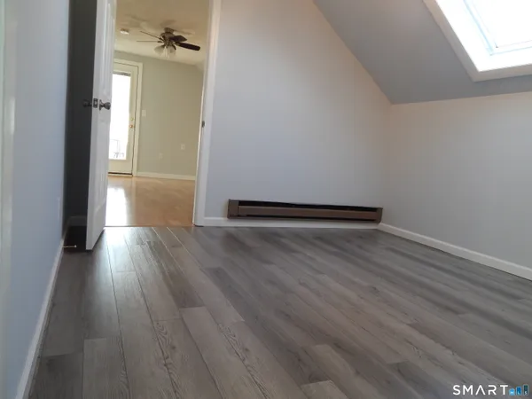 a view of a hallway with wooden floor