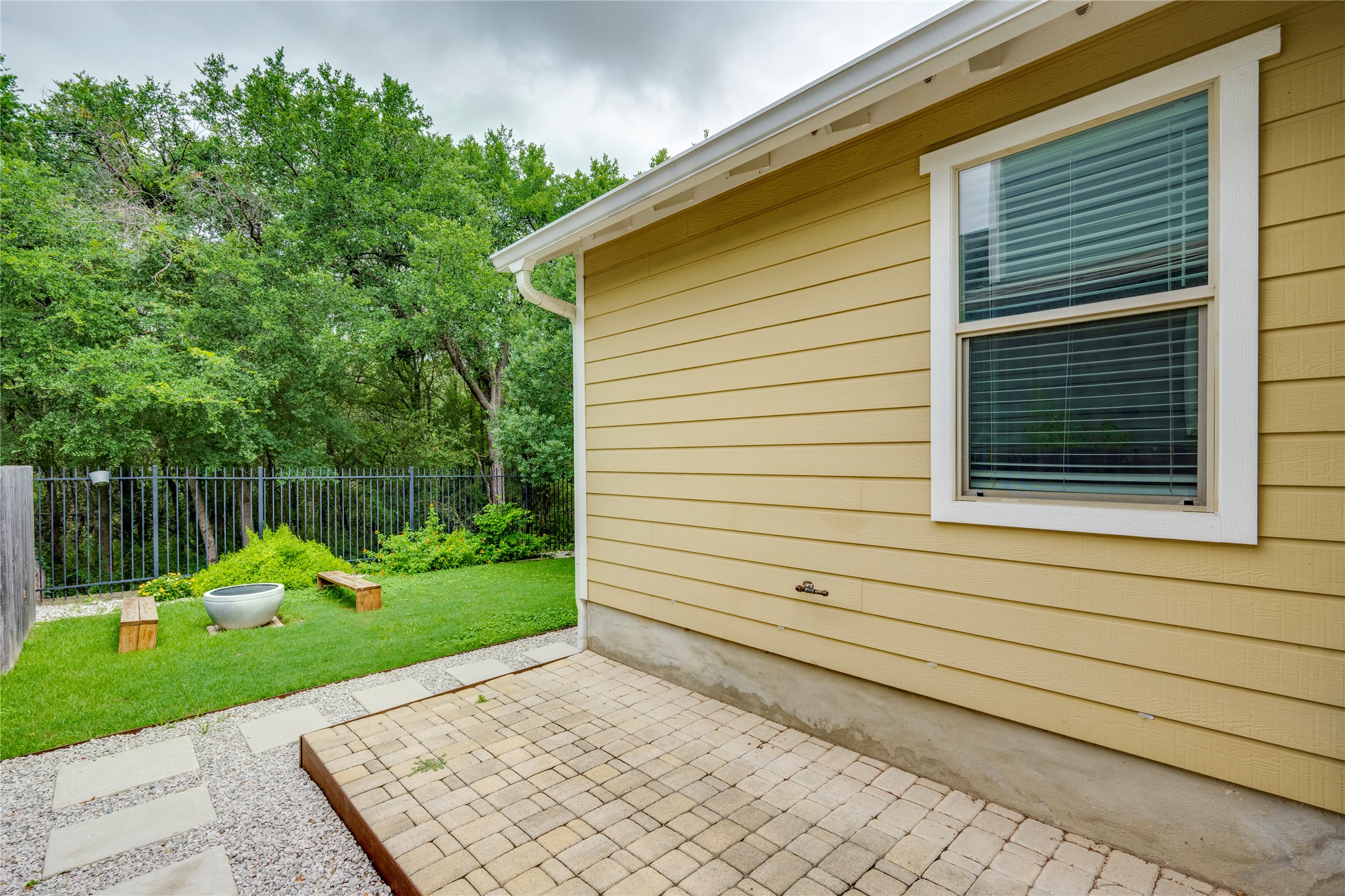 6008 Whipple Way Austin, TX 78745 - Photo 34 of 39 An inviting backyard features a paved patio, lush lawn, and private fencing, perfect for outdoor enjoyment.