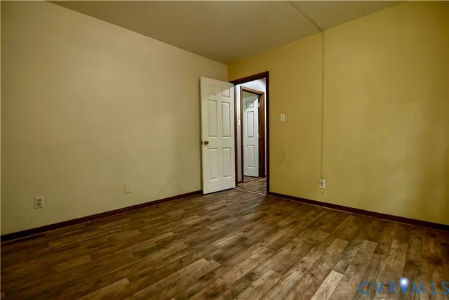 a view of an empty room and wooden floor