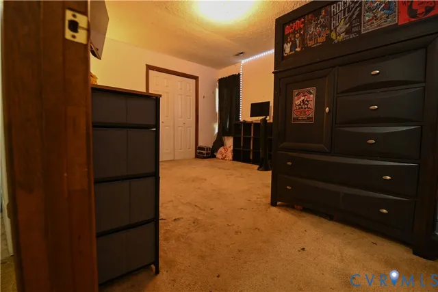 a bedroom with a bed and a flat tv screen