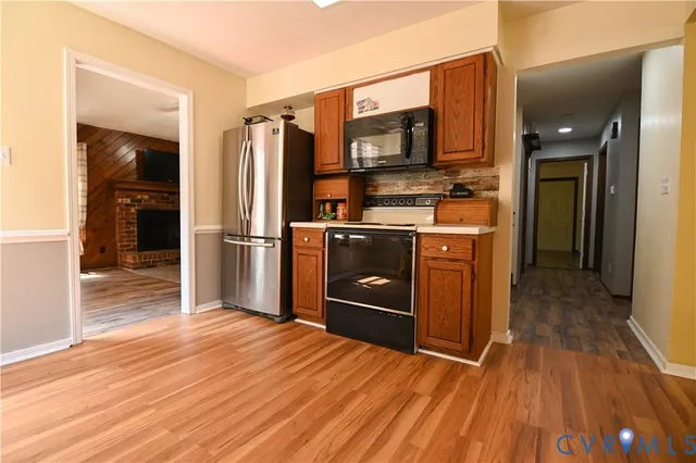a kitchen with stainless steel appliances granite countertop a refrigerator stove and sink