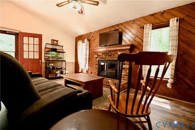a living room with furniture a fireplace and a flat screen tv