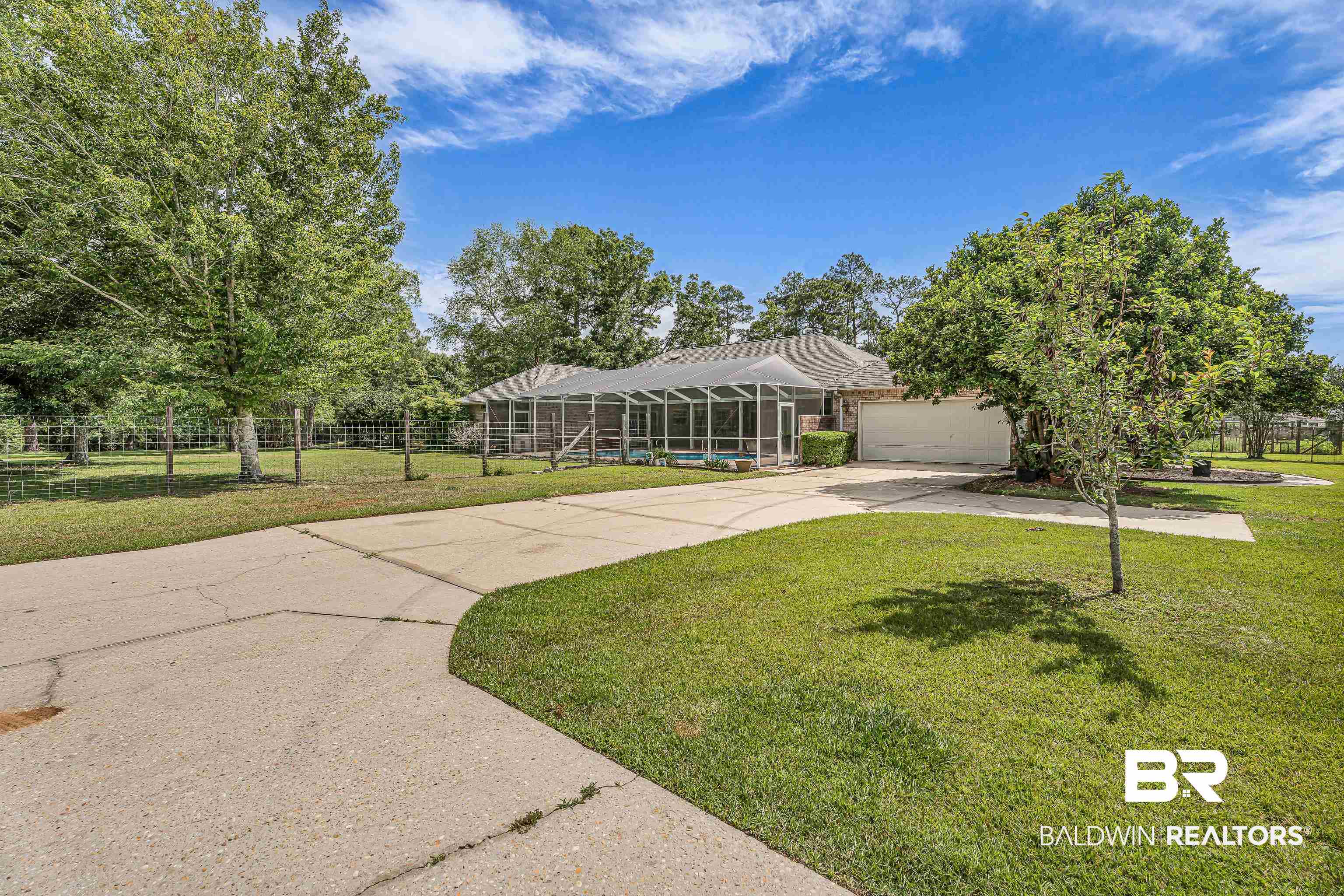 9530 Pilgrim Drive Elberta, AL 36530 - Photo 39 of 61 Ranch-style house featuring a front yard, a garage, glass enclosure, fence, and concrete driveway