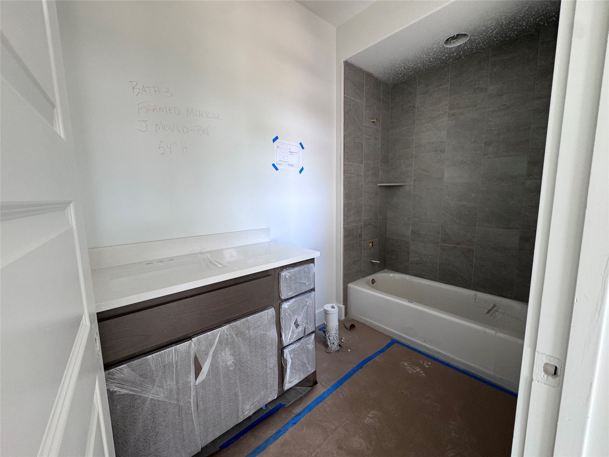 128 Rancho Deluxe Liberty Hill, TX 78642 - Photo 8 of 15 A fresh bathroom design showcases a modern vanity and a tiled bath enclosure.