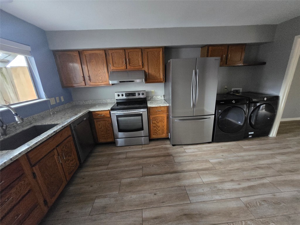 6401 Deihl Road, Unit 1006 Houston, TX 77092 - Photo 1 of 19 a kitchen with granite countertop a refrigerator stove and sink
