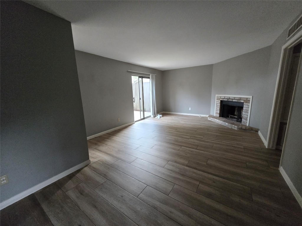 6401 Deihl Road, Unit 1006 Houston, TX 77092 - Photo 7 of 19 wooden floor in an empty room with a window