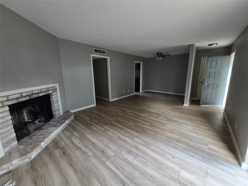 6401 Deihl Road, Unit 1006 Houston, TX 77092 - Photo 8 of 19 a view of empty room with wooden floor and fireplace