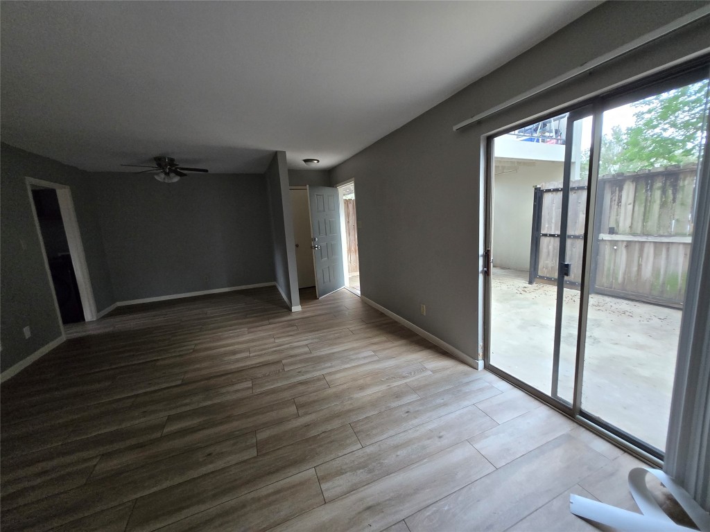 6401 Deihl Road, Unit 1006 Houston, TX 77092 - Photo 9 of 19 an empty room with wooden floor and sliding door