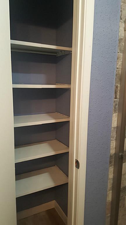 6401 Deihl Road, Unit 1006 Houston, TX 77092 - Photo 9 of 19 a view of walk in closet with empty racks